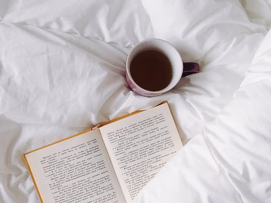 white ceramic mug on white textile